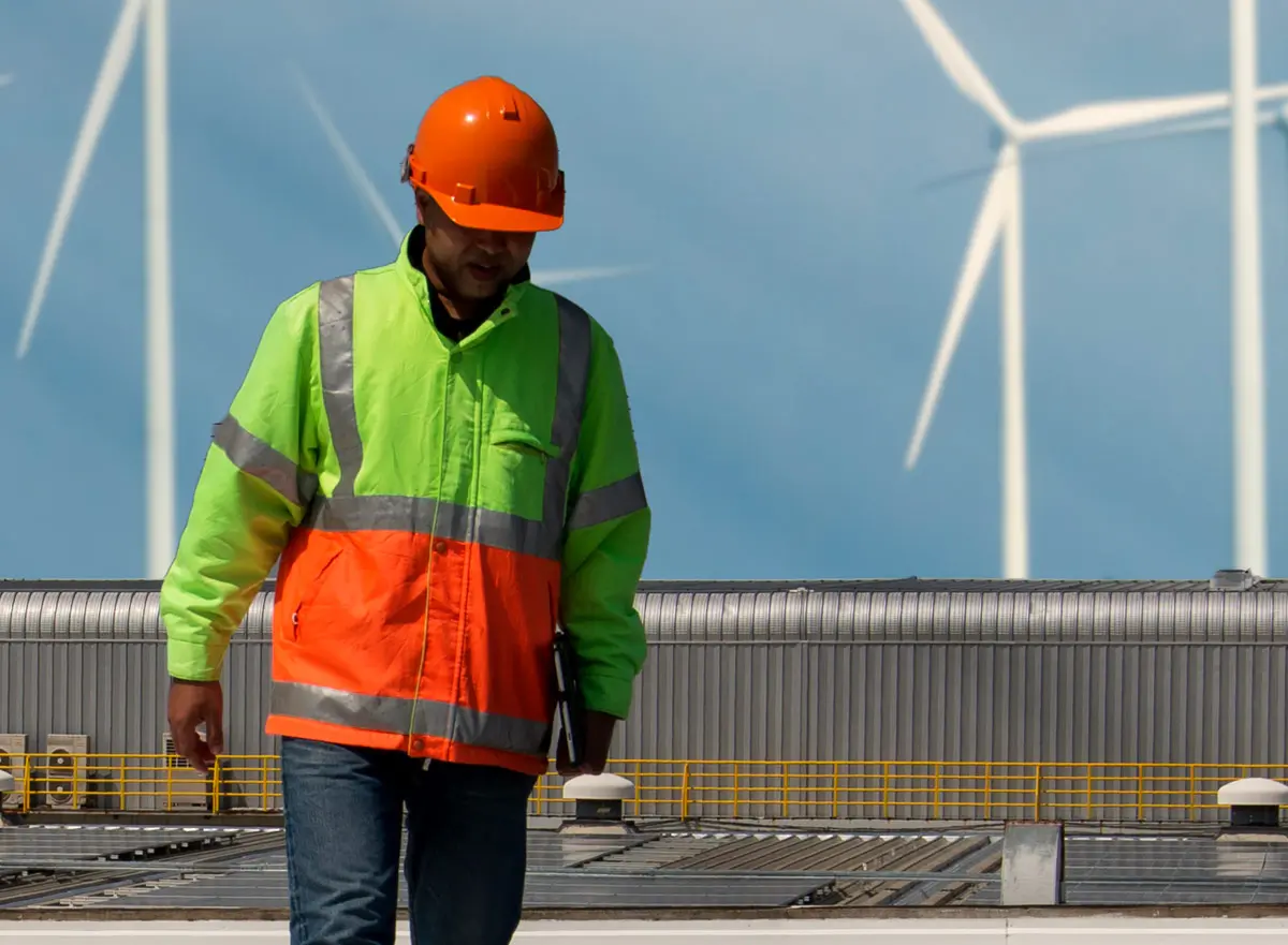 Employee with wind turbines in the background